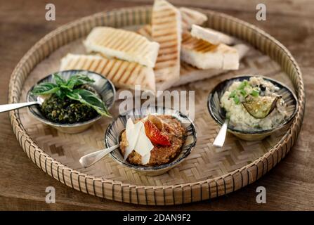 vegetarian turkish mezze snack tapas platter on rustic wood restaurant table Stock Photo