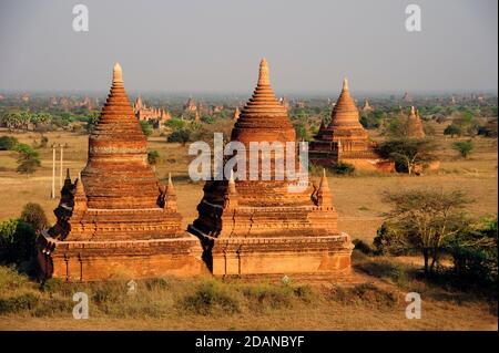 Two brick temple structures on the temple studded dusty plain of ancient Bagan Myanmar Stock Photo