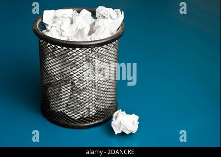 office bin filled with crumpled paper Stock Photo