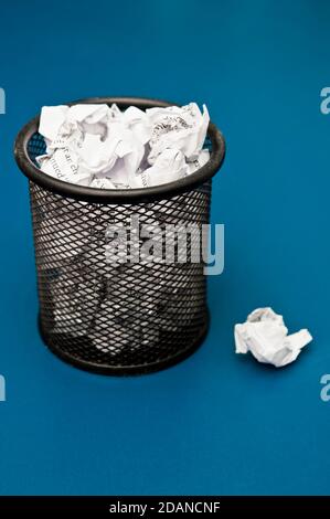 office bin filled with crumpled paper Stock Photo