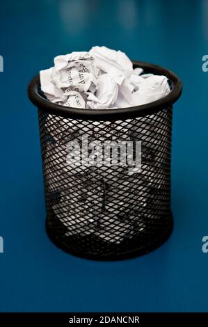 office bin filled with crumpled paper Stock Photo