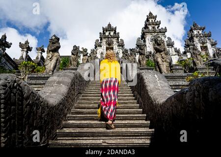 young woman standing on the stairs to temple Stock Photo