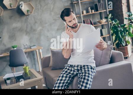 Portrait of his he nice attractive serious professional brunet guy working remotely calling partner discussing document at modern loft brick Stock Photo