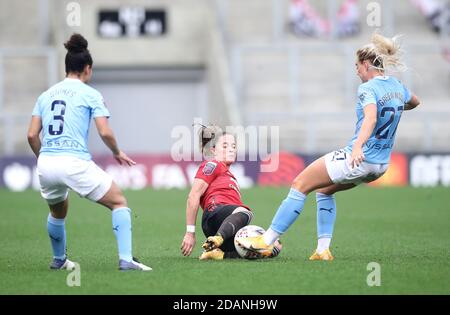 Manchester United's Ona Batlle (centre) and Manchester City's Alex Greenwood (right) battle for the ball during the FA Women's Super League match at Leigh Sports Village. Stock Photo