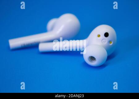 Wireless Blue-tooth Earphone or Ear bud. Air Pods wireless Blue-tooth headphones. Stock Photo