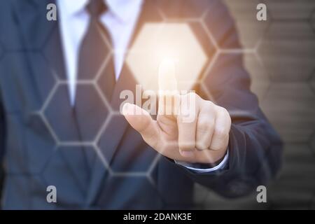 Businessman hand pressing button on virtual screen. Idea for technology, internet and business. Stock Photo