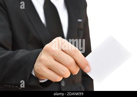 Man's hand in suit holding white business card isolated on white background, with clipping path. Stock Photo
