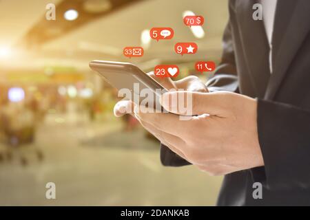 Businessman using smartphone with social network icon , Copy space. Idea for business, online banking, technology, send sms. Stock Photo
