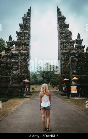 young woman standing in front of buddhist gate with dark mood Stock Photo