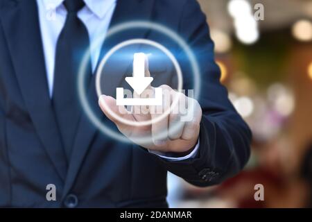 Businessman hand pushing web download icon on virtual touchscreen interface. Stock Photo