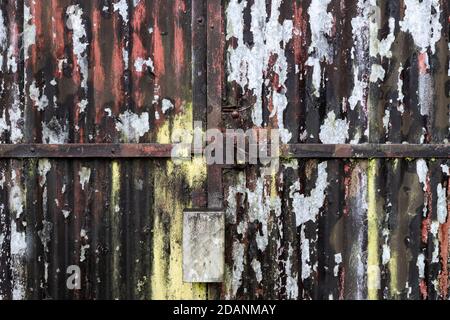 Old corrogated iron door with peeling paint Stock Photo