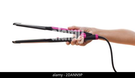 Child hand holding curling iron isolated on white background. with clipping path. Stock Photo