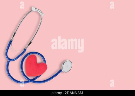 Stethoscope medical and red heart on pink background. Idea for health care concept. Copy space for text. Stock Photo