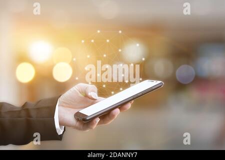 Closeup of hand holding smartphone with network connection. Wireless connect futuristic concept. Stock Photo