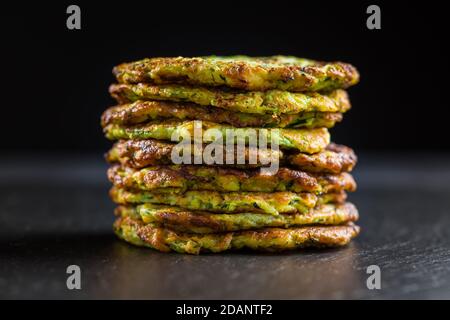 Zucchini pancakes on black background Stock Photo