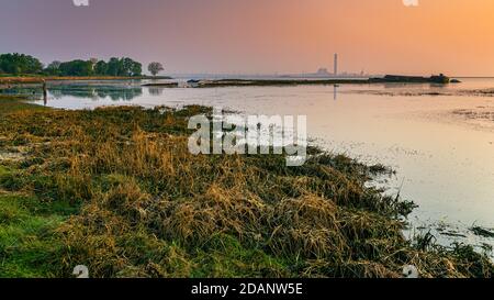 Kingsnorth Power Station At Sunrise On The Isle Of Grain Looking From The Riverside Country Park In Medway Kent Stock Photo