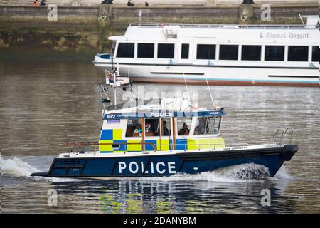 Views over the Thames from the Victoria Tower Gardens London  Metropolitan river police launch Stock Photo