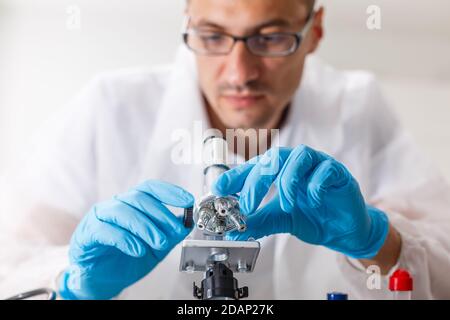 young male researcher carrying out scientific research in a lab Stock Photo