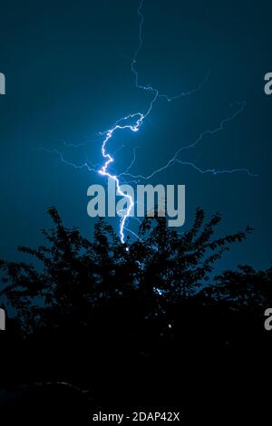 Thunderbolt of lightning strikes down from a severe thunderstorm Stock Photo