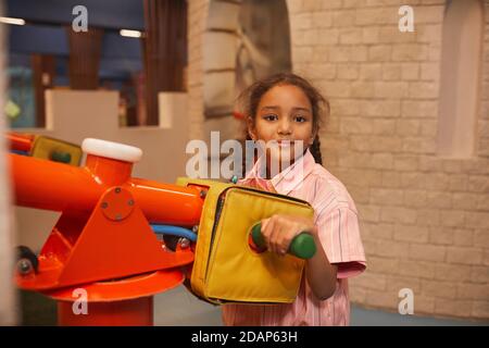 Portrait of cute African little girl spending her leisure time in the park Stock Photo