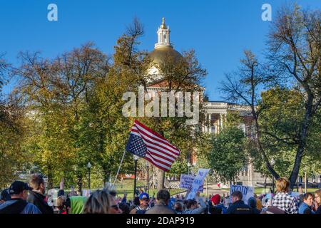 Protesters at anti-Trump Love Rally in Boston Common following the US presidential election with upside down US flag. The Massachusetts State House in Stock Photo