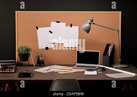Workplace of engineer with papers on board in front of table with supplies Stock Photo