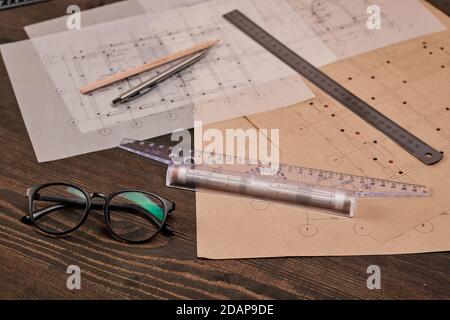 Eyeglasses, pen with pencil and rulers on several blueprints of new buildings Stock Photo