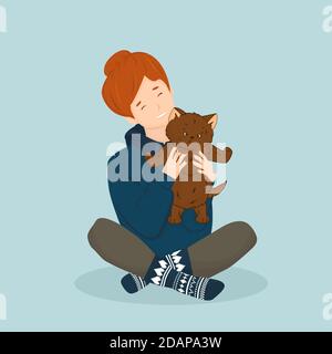 Red girl in hoodie and knitted christmas blue socks holds cute fluffy brown cat or kitten. Isolated cartoon hand drawn picture, blue background Stock Vector