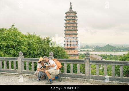 Couple selfie at Bai Dinh Pagoda, Ninh Binh, tourists visiting the biggest buddhist temple complex in Vietnam, tourist religious travel destination. S Stock Photo