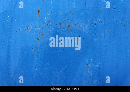 Beautiful old blue paint on wall surface. Abstract blue wall texture with cracks and rusty Stock Photo