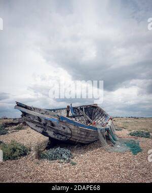 A fishing boat on the stark landscape of Dungeness in Kent, UK. Stock Photo