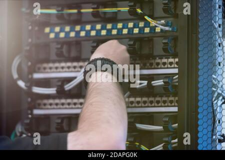 Young it engeneer business man with thin modern aluminium laptop in network server room. Young it engeneer in datacenter server room Stock Photo