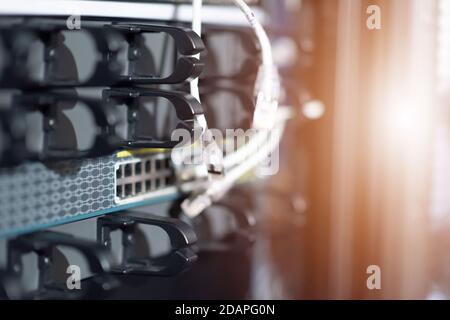 Young it engeneer business man with thin modern aluminium laptop in network server room. Young it engeneer in datacenter server room Stock Photo