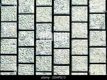 small cobblestone sidewalk made of cubic stones - tileable texture, gray on the sidewalk Stock Photo