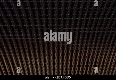 Perforated panels of suspended ceiling. Low angle close-up photo of office building interior fragment. Abstract background on the subject of modern ar Stock Photo