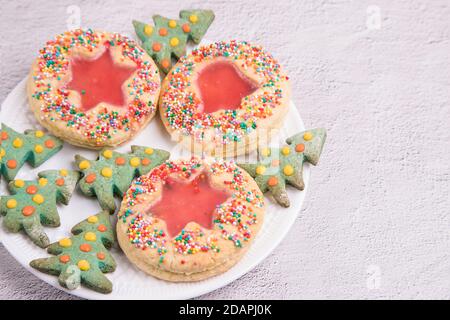 Christmas cookies on a white plate, light background. Close-up, copy space Stock Photo