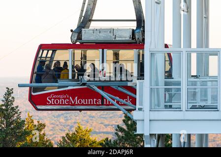 Passengers leaving the mountaintop terminal of the Stone Mountain Park Summit Skyride at sunset in Stone Mountain Park, just east of Atlanta, Georgia. Stock Photo