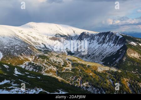 Lawn covered with white snow. Majestic spring sunny day. Beautiful landscape of high mountains and forests. Wallpaper background. Location place Carpa