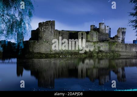 5 minute long exposure of Caerphilly Castle taken at night that includes star trails Stock Photo