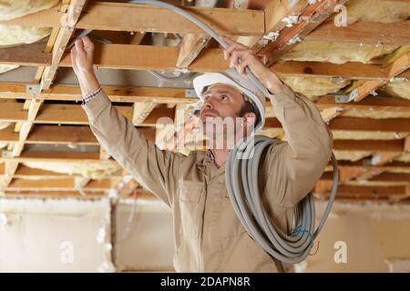 male worker checking ceiling pipes Stock Photo