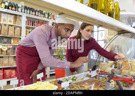 bakery employees offering different pastry for sale Stock Photo