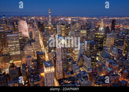 Aerial evening view of Midtown New York City skyline along Fifth Avenue. Illuminated Manhattan skyscrapers, NYC.USA Stock Photo