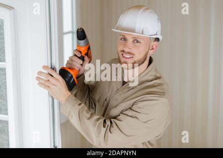 happy man using a drill Stock Photo