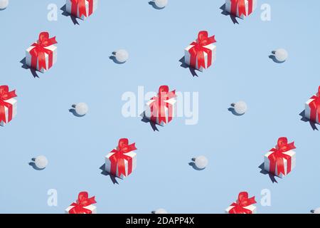 Pattern of gift boxes and white balls decorations on pastel blue background. Minimal style. Christmas or New Year concept. Stock Photo