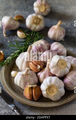Healthy food. Garlic Cloves and Bulb on a stone or slate table. Stock Photo