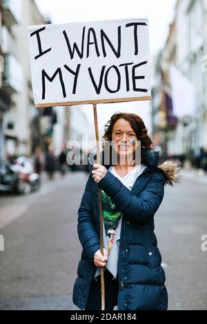 LONDON, UK - A anti-brexit protester holds 'I want may vote' placard during Anti Brexit protest on March 23, 2019 in London. Stock Photo