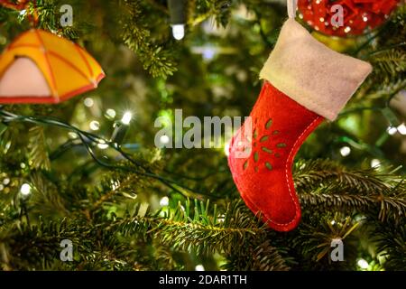 Stocking Ornament with String of Lights on Christmas Tree Stock Photo