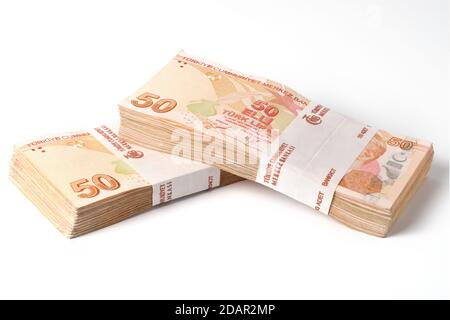 Two stacks of one hundred pieces fifty turkish lira bills isolated on white Stock Photo