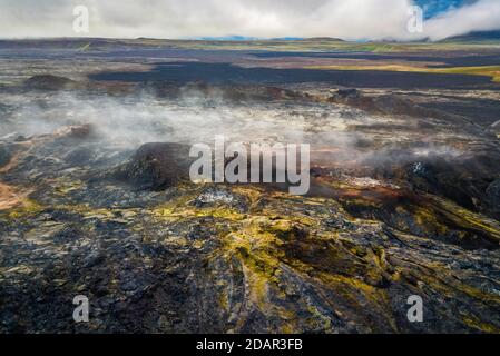 Aerial view of the steaming Krafla lava field with colorful rocks, Skutustaoir, Norourland eystra, Iceland Stock Photo