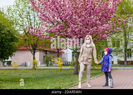 mother and little young daughter wearing mask for prevent dusk pm 2.5 bad air pollution on deck in city 2020. Stock Photo